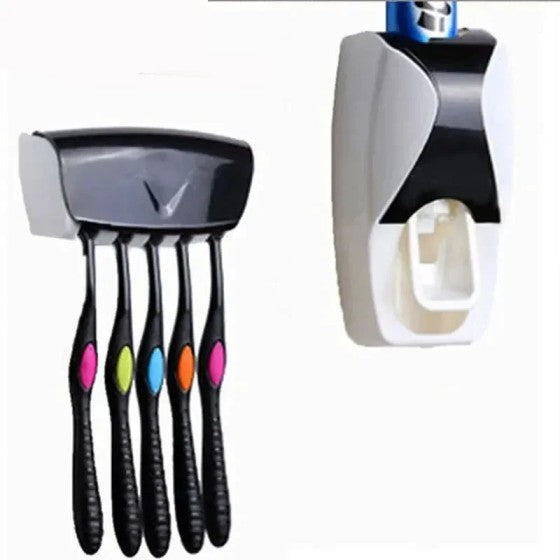 Set of five black toothbrushes with colorful bristles and toothpaste dispenser on a white background.