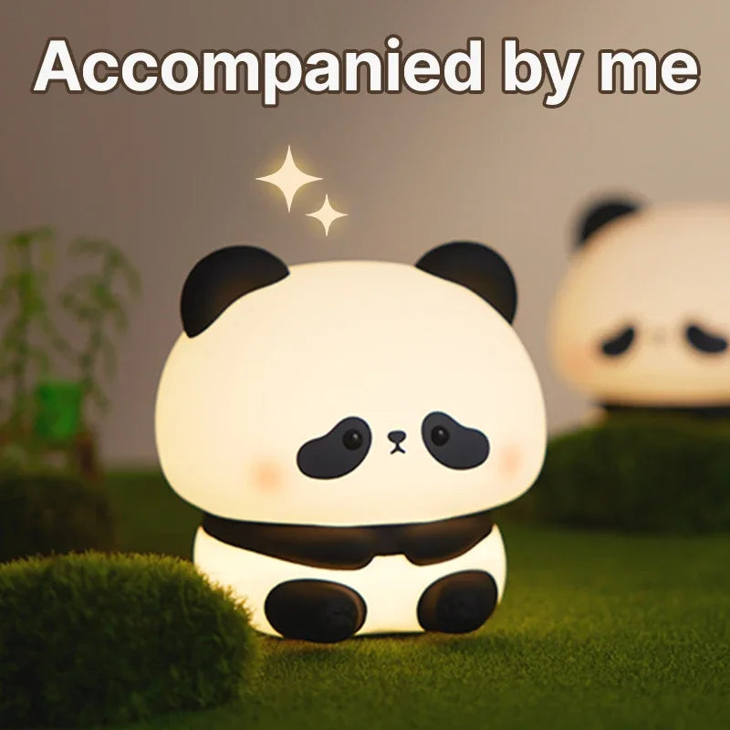 Cute panda night light on a grassy surface with a blurred background