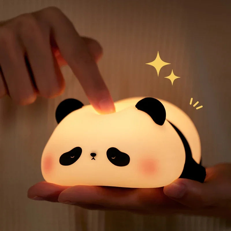 Cute panda-shaped night light being held by a hand with a warm glow.