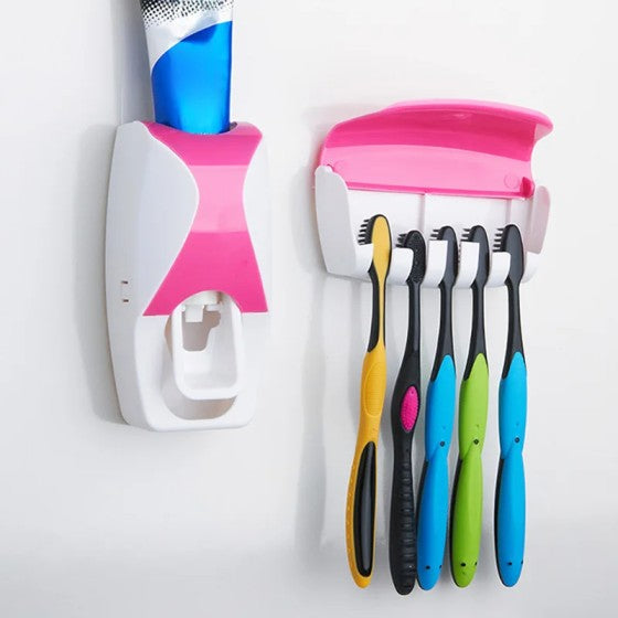 Colorful toothbrushes with a holder and toothpaste dispenser on a white background