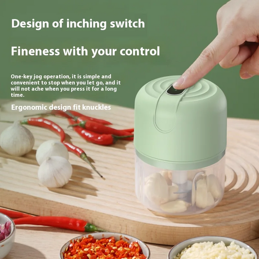 mini electric chopper on a wooden cutting board with garlic and peppers, text about switch design and control.